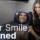patient smiling looking in the mirror at her smile